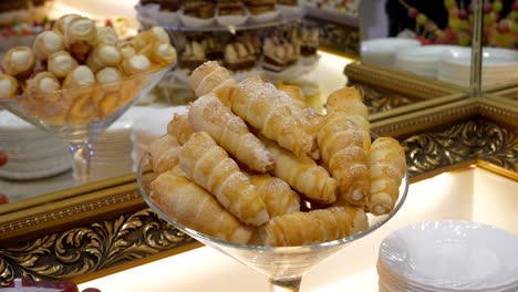 Sweet-pastry-tubes-filled-with-whipped-cream-arranged-on-an-elegant-table