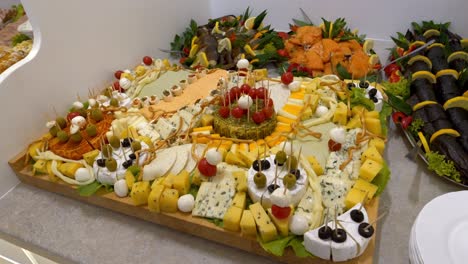 Cheese-board-adorned-with-cherry-tomatoes,-olives,-and-mozzarella-balls