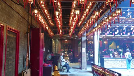 Inside-Tin-Hau-Temple,-Hong-Kong-and-Lotus-lamps-with-tags-of-wishes