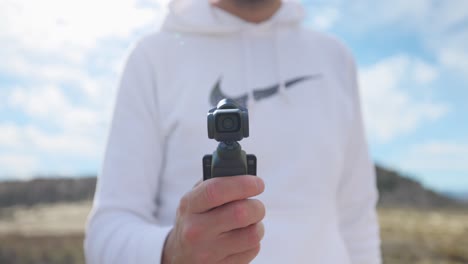 Vlogger-activating-modern-DJI-Osmo-Pocket-3-stabilized-intelligent-tracking-mobile-gimbal-camera-for-creative-videography