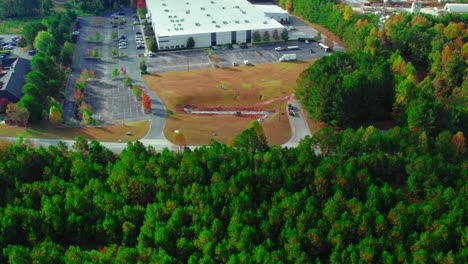 Establishing-aerial-of-Construction-workers-laying-drainage-pipes-into-the-ground,-job-site-in-Georgia,-USA