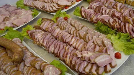 Platter-with-slices-of-ham,-bacon,-and-sausage