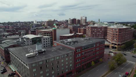 Aerial-take-off-over-Portland-city-neighborhood-area-building-rooftops,-Maine