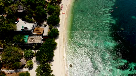 A-overhead-aerial-drone-shot-panning-from-bottom-to-the-top,-revealing-the-tip-of-the-peninsula-of-Sai-Daeng-private-beach-resort-in-Koh-Tao-Island-in-Surat-Thani-province-in-Thailand