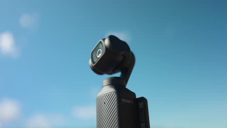 Activating-new-modern-DJI-Osmo-Pocket-3-stabilized-handheld-gimbal-compact-mobile-camera-with-sky-in-background-for-copy-space