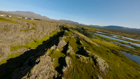 Aerial-establishing-shot-of-tourists-exploring-the-Thingvellir-Canyon-in-iceland