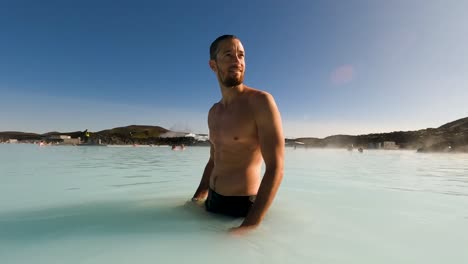 Slow-motion-shot-of-a-man-relaxing-in-the-blue-lagoon-thermal-spa-in-Iceland