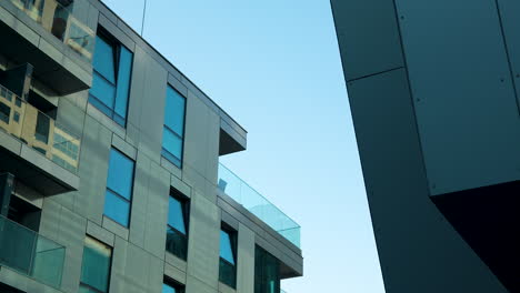 Eckiges,-Modernes-Gebäude-Mit-Glasbalkonen-Vor-Klarem-Himmel