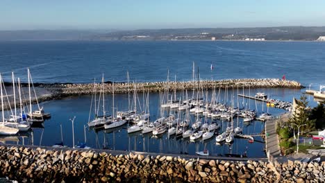 Aerial-Shot-of-Sailboats-Yachts-Moored-in-a-Harbor-at-Daylight-in-Chile,-South-America