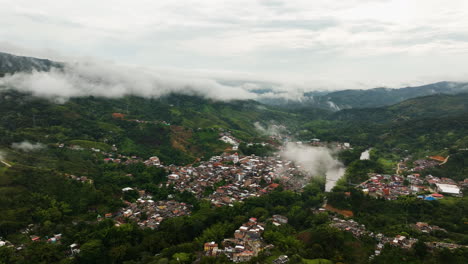 Aerial-view-rising-away-from-the-San-Rafael-Town,-in-cloudy-Antioquia,-Colombia