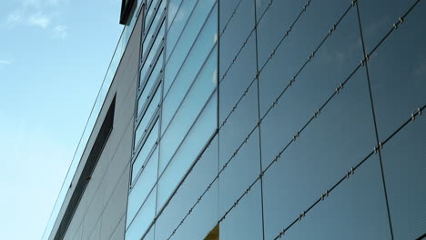 Close-up-of-modern-building's-glass-facade-with-steel-cables
