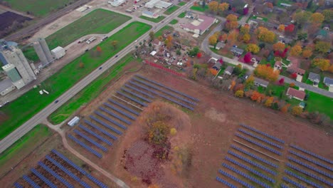 Aerial-of-Solar-panels-in-autumn-fields-highlight-the-synergy-of-modern-energy-and-traditional-farming,-Atwater,-Minnesota,-USA