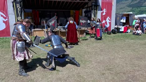 A-sword-fighting-scene-performed-by-Burdyri,-a-professional-sword-and-stage-combat-team,-during-the-South-Tyrolean-Medieval-Games
