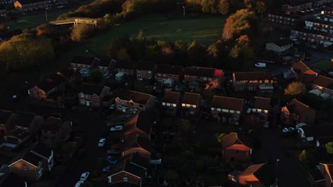 British-neighbourhood-housing-aerial-view-looking-down-over-early-morning-sunrise-autumn-coloured-village-rooftops