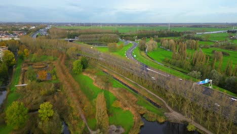 A10-Amsterdam-ring-road-highway-at-Amsterdam-Noord-surrounded-green-fields-and-trees