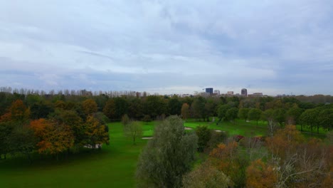 Crane-up-of-Amsterdam-Noord-cityscape-skyline-with-outdoor-golf-club-in-front