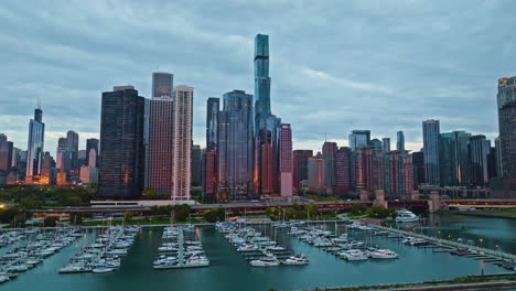 Aerial-tracking-shot-of-the-New-Eastside-and-Dusable-harbor,-sunrise-in-Chicago