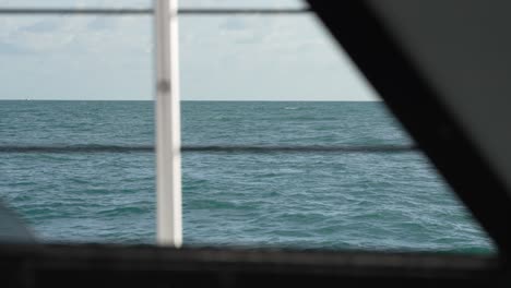 Ocean-Out-Window-Of-Sailboat-Catamaran-Cinematic-Golden