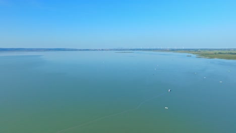 Boats-Floating-On-Calm-Waters-Of-Lake-Neusiedl-In-Austria
