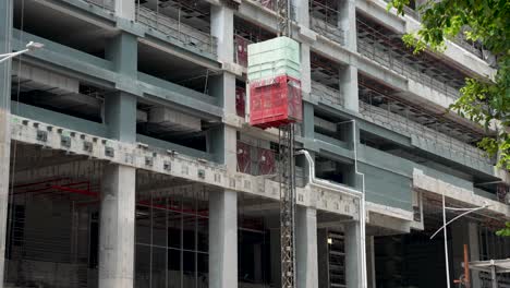 External-Lift-Moving-Down-At-Construction-Site-In-Downtown-Singapore
