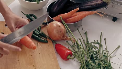Overhead-view-of-cutting-out-part-of-a-leftover-carrot-to-avoid-food-wastage,-shows-a-sustainable-and-zero-waste-lifestyle