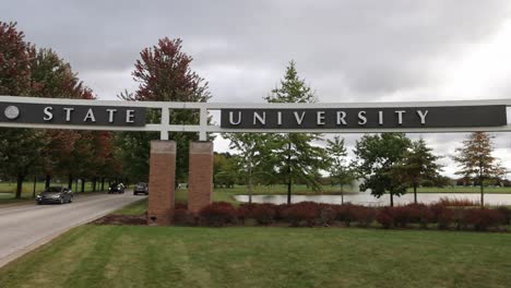 Entrance-with-cars-driving-on-the-campus-of-Saginaw-Valley-State-University-in-University-Center,-Michigan