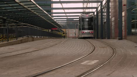 Public-transit:-Modern-passenger-train-stops-on-quiet-city-street