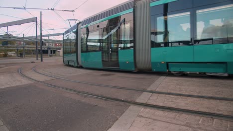 Shiny-new-public-transit-street-tram-turns-corner-in-Helsinki-Finland