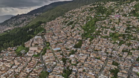 Medellin-Colombia-Aerial-v44-drone-flyover-Los-Mangos-and-Llanaditas-capturing-residential-hillside-Comuna-8-and-Villa-Hermosa,-houses-on-the-steep-slopes---Shot-with-Mavic-3-Cine---November-2022