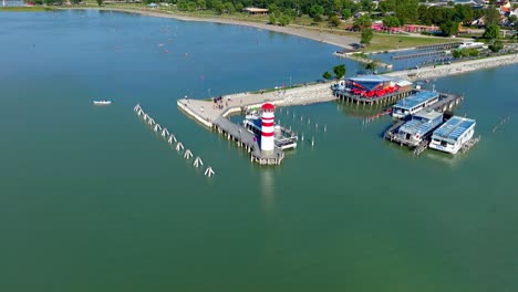 Lake-Neusiedl,-Austria---A-View-of-the-Lake's-Lighthouse-and-Port---Drone-Orbit