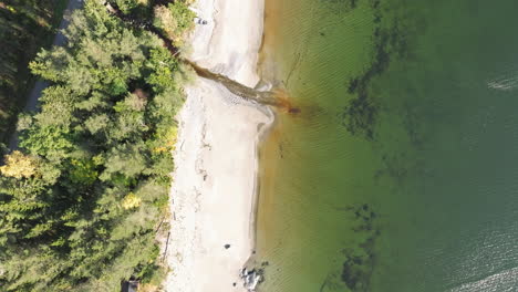 Overhead-Of-White-Sand-Beach-With-Crystal-Clear-Water-In-Sweden-During-Sunny-Day