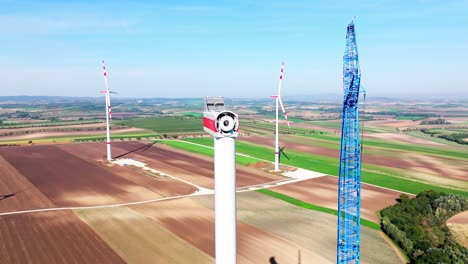 Wind-Turbine-Tower-Erected-With-Nacelle-Next-To-Construction-Crane-On-Wind-Farm