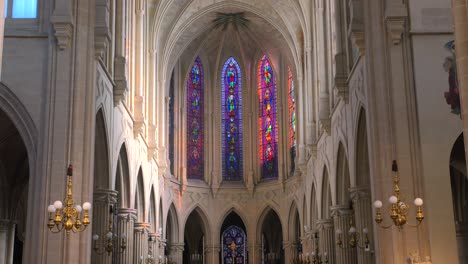 Tilt-up-shot-of-dimly-lit-alter-in-the-interior-of-a-roman-catholic-church-of-Saint-Germain-l'Auxerrois-in-Paris,-France