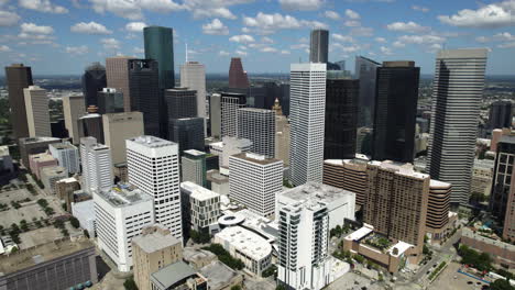 Aerial-tracking-shot-in-front-of-the-city-center-of-Houston,-in-sunny-Texas,-USA