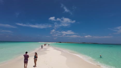 Couple-Walking-And-Talking-On-Paradise-Sandbank-Beach-Cayo-De-Agua-Los-Roques-Venezuela