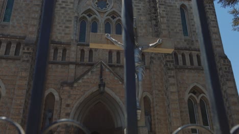 Sliding-shot-of-Jesus-Christ-on-a-cross-in-front-of-cathedral