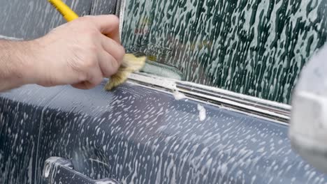 Cleaning-car-trim-with-a-detailing-brush
