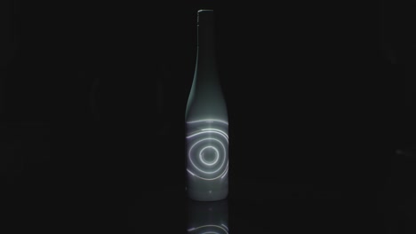 A-Spinning-Light-Is-Projected-Onto-A-White-Bottle