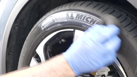 Applying-tyre-dressing-to-car-wheel
