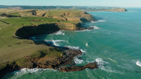 Aerial-view-of-wild-and-rugged-coastline-of-Slope-Point,-in-the-Catlins-region-of-NZ,-and-the-southernmost-point-of-the-South-Island-of-New-Zealand-Aotearoa