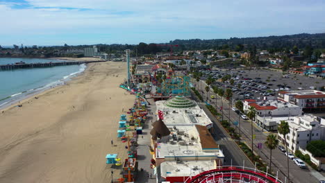 Drone-shot-backwards-over-the-Santa-Cruz-Beach-Boardwalk,-in-California,-USA