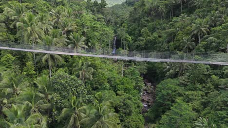 Aerial-Panning-Shot-of-Hanging-Rope-Bridge-in-Jungle-of-Alegria,-Philippines