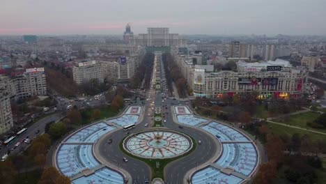 Reverse-aerial-dolly-view-from-drone,-overlooking-to-the-famous-Bulevardul-Unirii-and-the-romanian-Parliament-in-the-background-during-afternoon-time