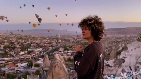 Woman-portrait-in-Turkey-Cappadocia-city-of-historical-ecotourism-erosion-rock-houses-building-in-Europe-the-landscape-of-a-traveler-road-trip-to-experience-hot-air-balloons-riding-mountain-landscape
