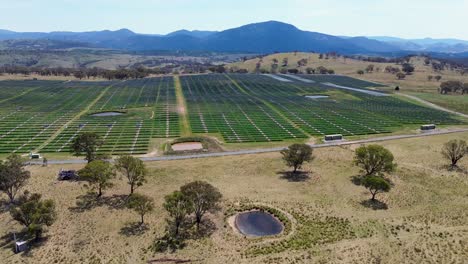Drone-aerial-landscape-scenic-view-Royalla-Solar-farm-panels-mountain-range-dam-trees-outback-country-Canberra-ACT-energy-tourism-industry-travel-electricity-technology-Australia-4K