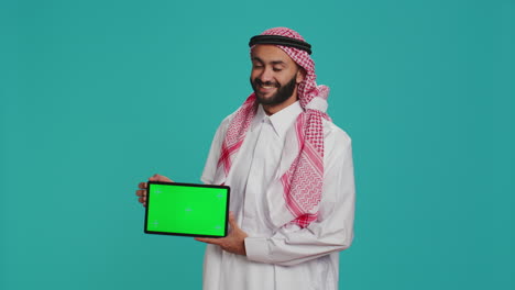 Muslim-man-presents-greenscreen-tablet