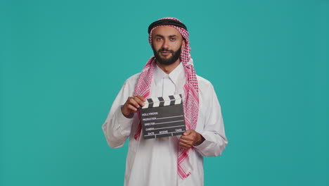 Middle-eastern-filmmaker-holds-clapboard