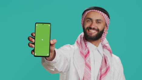 Man-on-mobile-device-with-greenscreen
