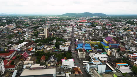 Aerial-establishing-flight-over-city-of-Surat-thani-with-colorful-buildings-in-Thailand---Forward-drone-shot