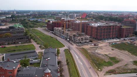 Aerial-approaching-shot-of-construction-site-on-residential-area-of-Gdansk-City